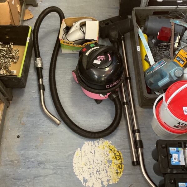 Pink Heety cylinder vacuum cleaner with handheld attachment.