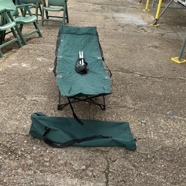 Green Hi Gear camping bed with carry bag, folded for storage.