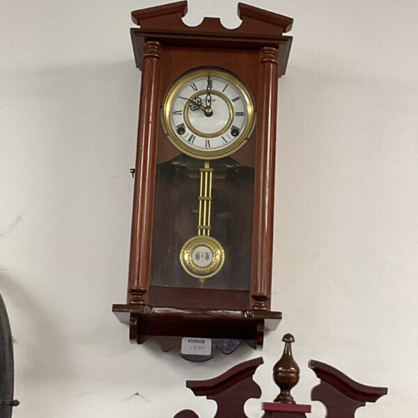 Antique Highlands wall clock with pendulum and striking mechanism.