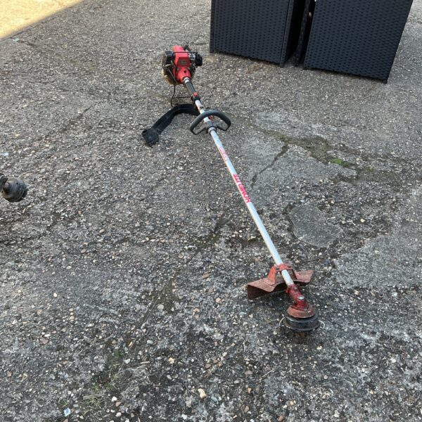 Used Homelite petrol garden strimmer for lawn and garden maintenance.