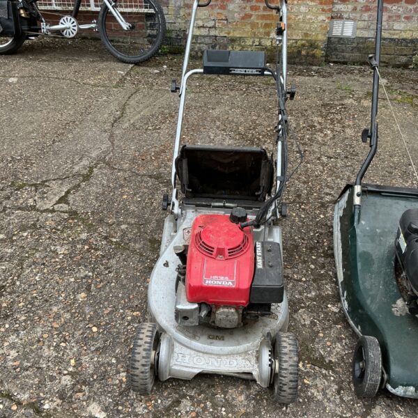 Honda petrol lawnmower in a garden setting, ideal for restoration.