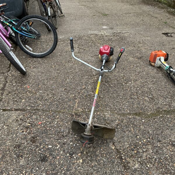 Used Honda petrol strimmer for garden landscaping and maintenance.