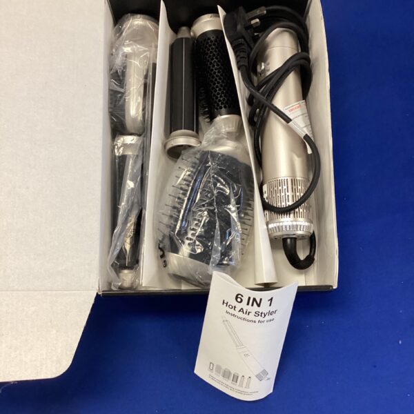 Six-in-one hot air styler with attachments in box.