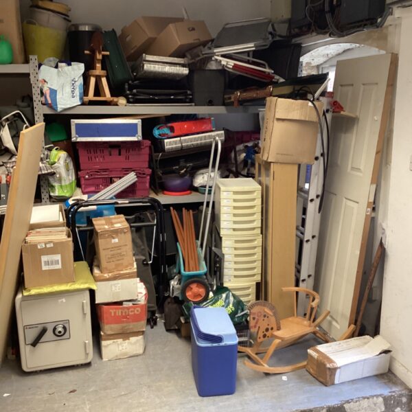 Large house clearance lot with stacked storage boxes and household items.