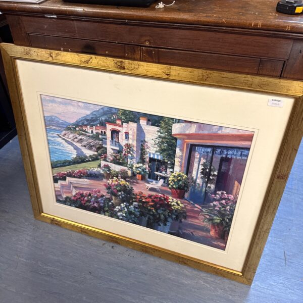 Large framed Howard Behrens print of a coastal patio scene.
