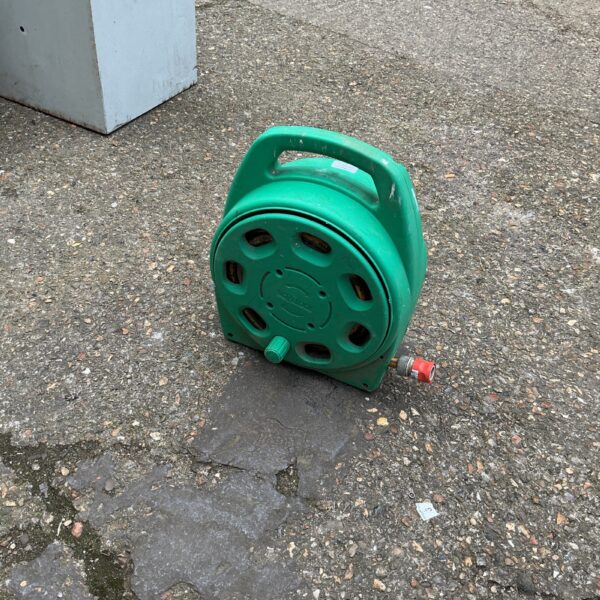 Green Hozelock hose reel for garden hose storage.