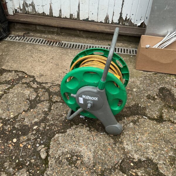 Used Hozlock hose reel in a garden setting.