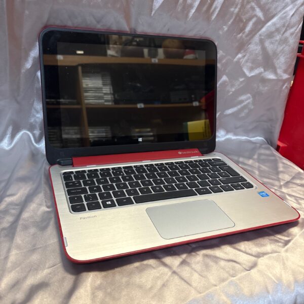 Red HP Pavilion laptop with Beats Audio branding.