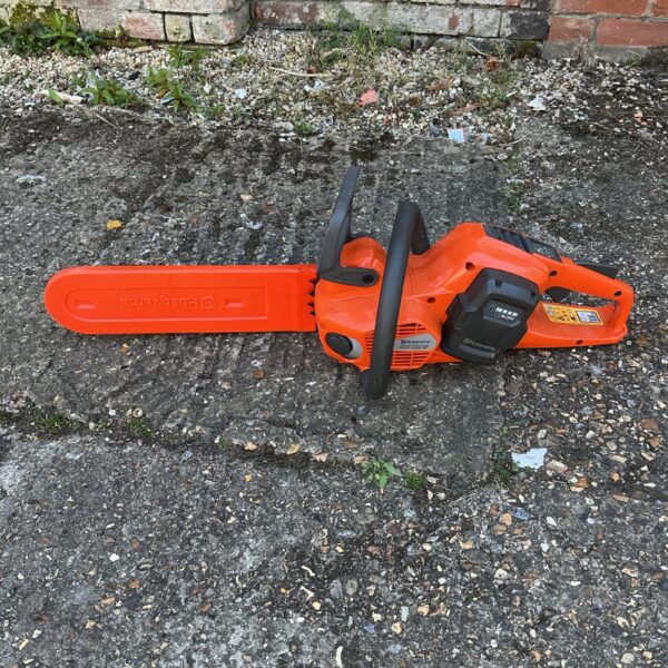 Front view of a used Husqvarna petrol chainsaw.