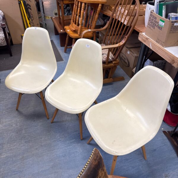 Set of three vintage IKEA dining chairs with pale cream seats.