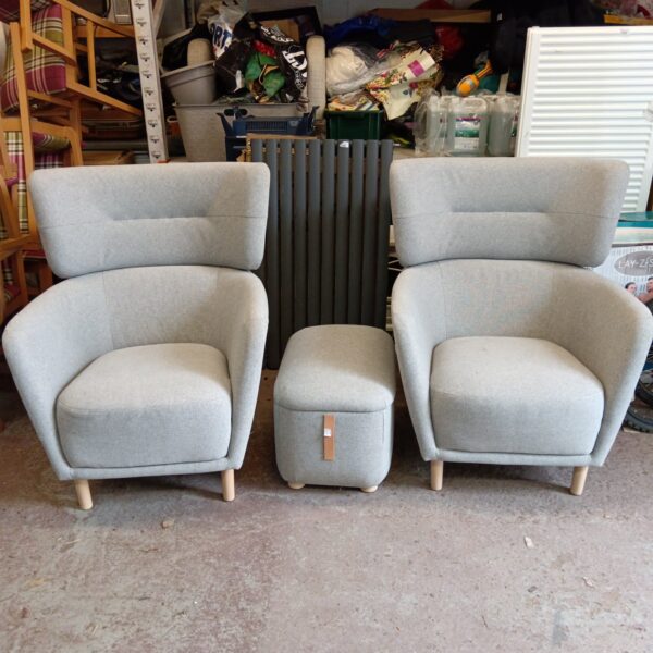 Grey IKEA armchair with footstool in a living room setting.