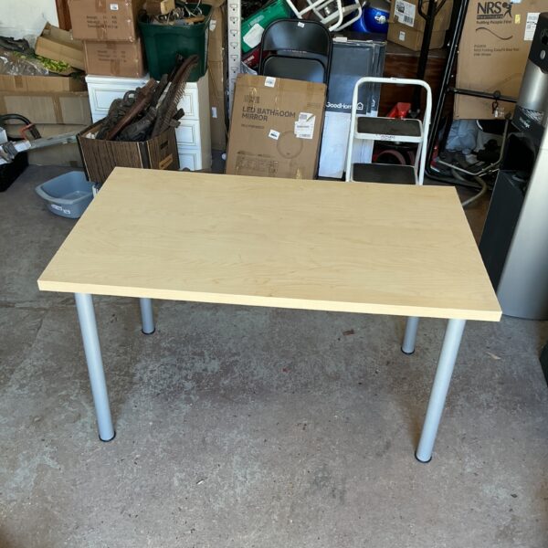 Small IKEA pine effect table with metal legs.