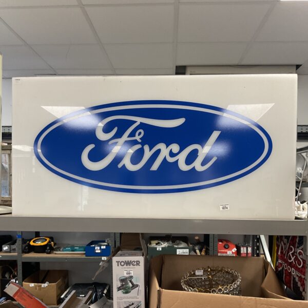 Illuminated Ford Motor Company sign with blue logo.