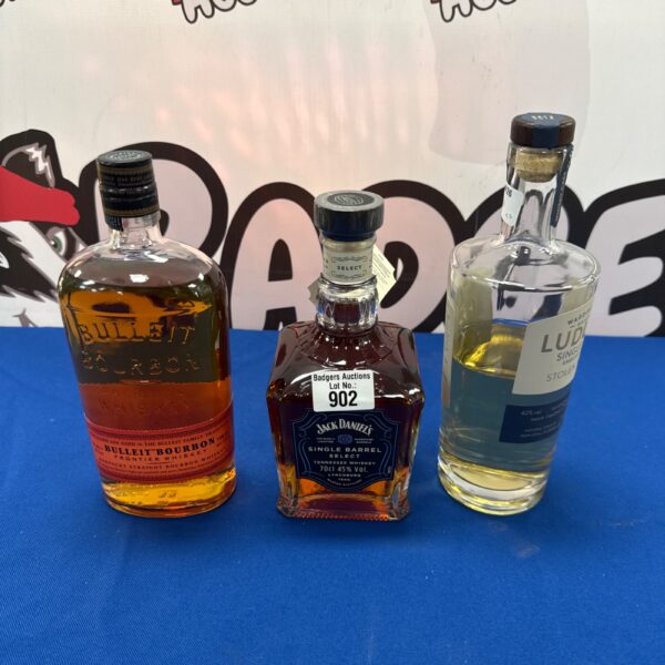 Sealed bottles of bulleit & Jack Daniels bourbon with part drunk bottle of ludlow stolen youth single malt whiskey
