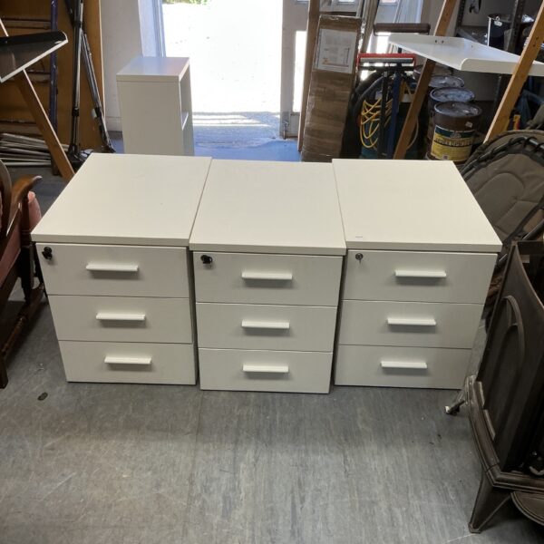 Three white under desk units with locks and keys