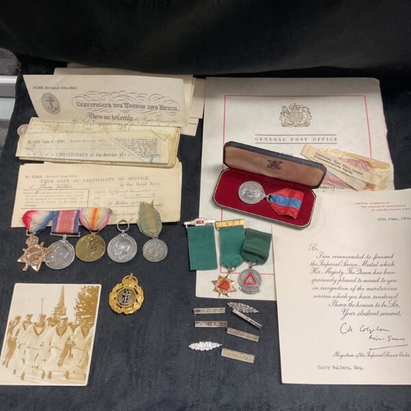 Imperial Service Medal collection with medals and documents.