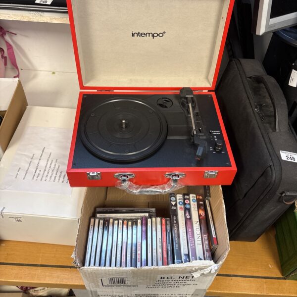 In Tempo portable turntable with included CDs and DVDs.