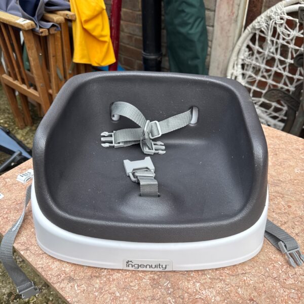 Ingenuity child seat riser for secure baby feeding.