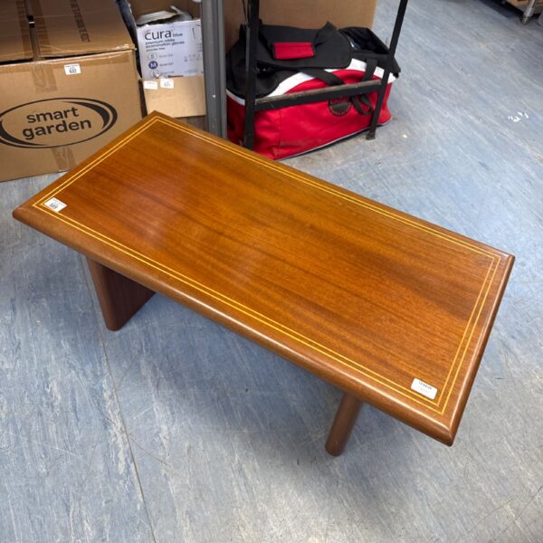 Vintage inlaid coffee table with detailed wood pattern.