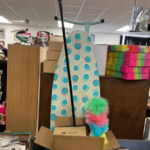 Polka dot patterned ironing board as part of a household lot.
