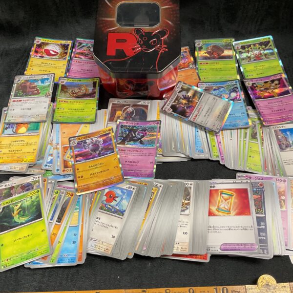 Large collection of Japanese Pokemon cards inside a tin.
