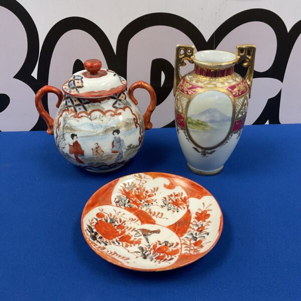 Antique Japanese porcelain collection featuring a bowl, vase, and sugar bowl.