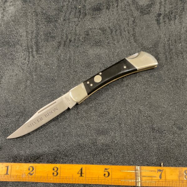 Vintage Japanese silver bison pocket knife, detailed handle.