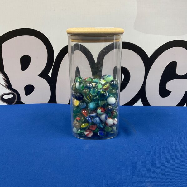 Colourful jar of vintage glass marbles for collectors.