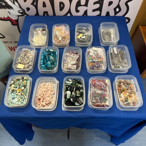 Assorted jewellery making beads and semi precious stones in plastic containers.