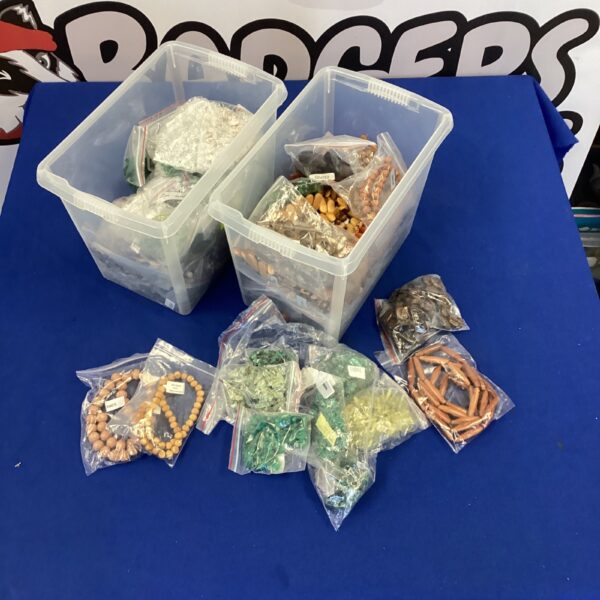 Assorted jewellery making beads in two tubs.
