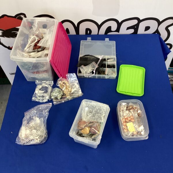 Assorted jewellery making supplies in plastic storage boxes.