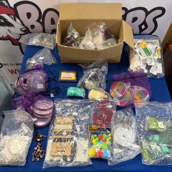 Colourful jewellery making supplies including beads and ribbons.