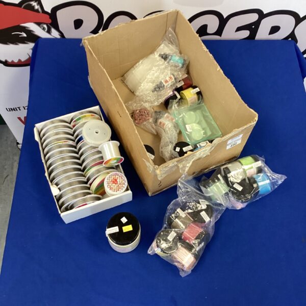 A box of colourful jewellery making wire and glitter.