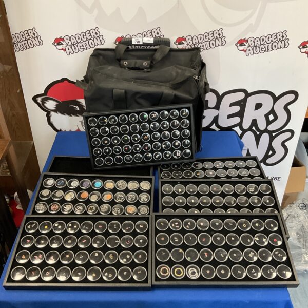 Black jewellery transit bag open with trays of pendants and studs.