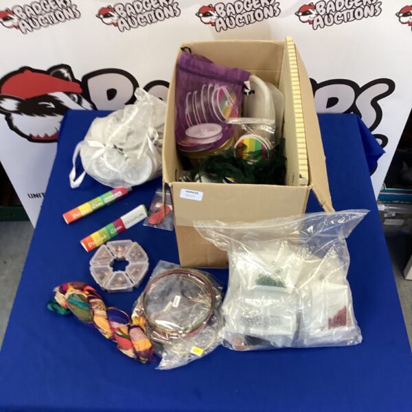 Colorful jewelry making supplies including beads, ribbon, and wire.