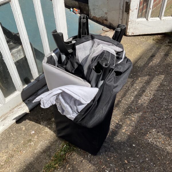 Joie A baby travel cot, folded and ready for transport.