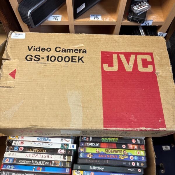 Vintage JVC video camera in original box with VHS tapes.