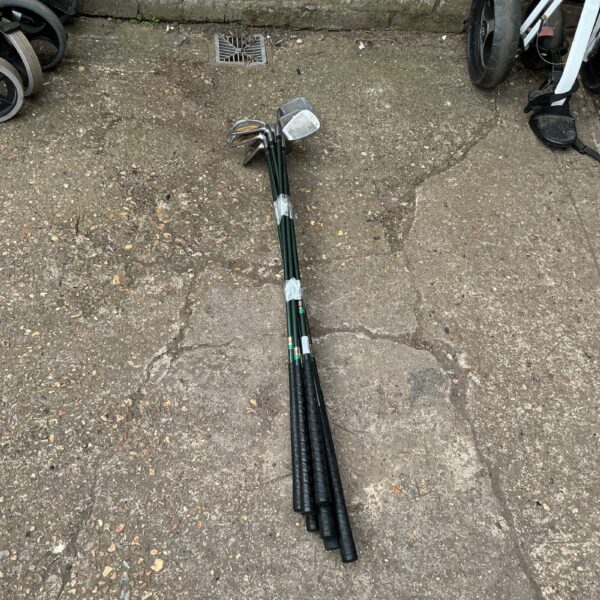 Vintage Keno golf club set with wooden shafts and metal heads.
