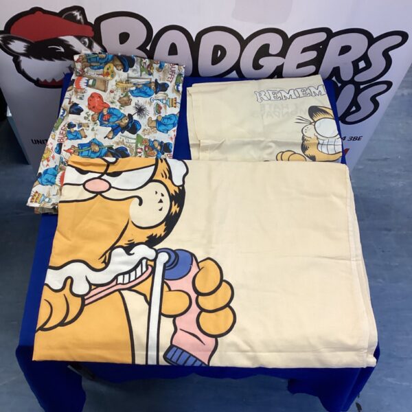Kids bedding set featuring Paddington Bear and Garfield designs.