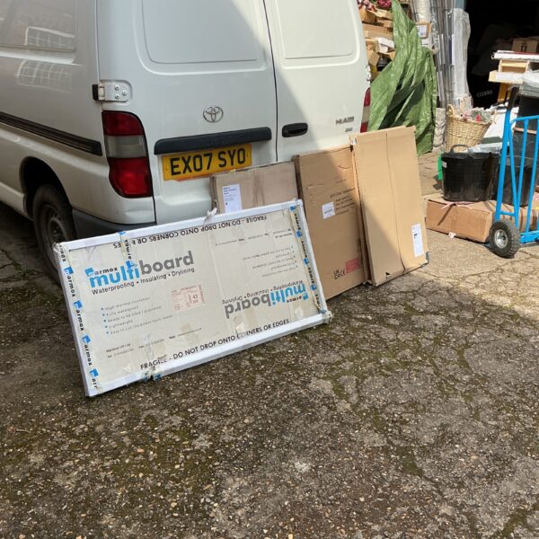 White PVC kitchen splashbacks and end panels stacked for storage.