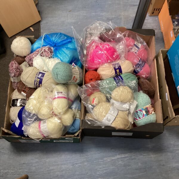 Mixed lot of colourful knitting wool for crafting projects.