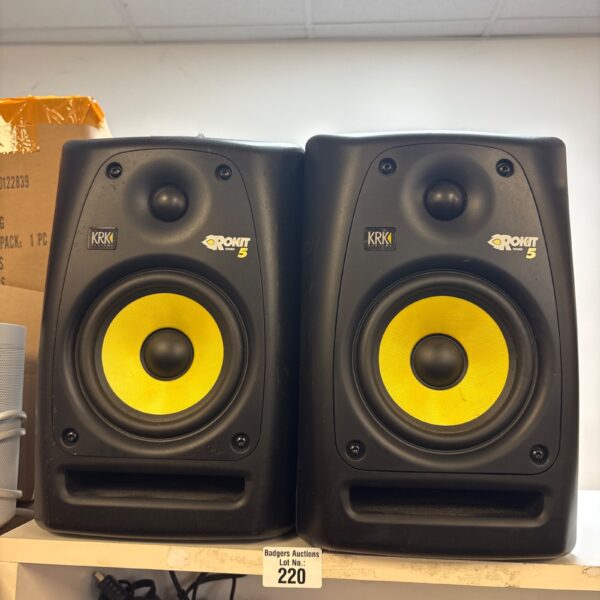 Pair of black KRK Rokit 5 studio monitors with yellow cones.