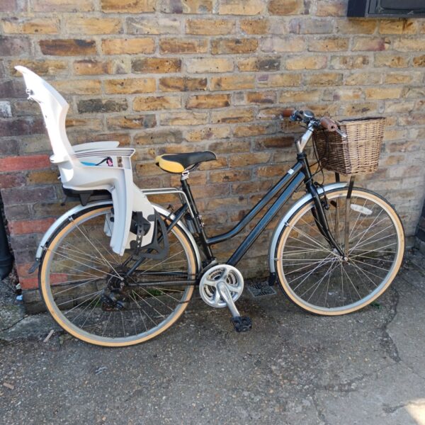 Ladies bicycle with child seat and basket, vintage style.