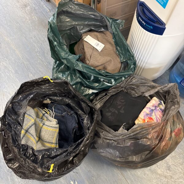 Three large black bags filled with ladies clothing bundle.