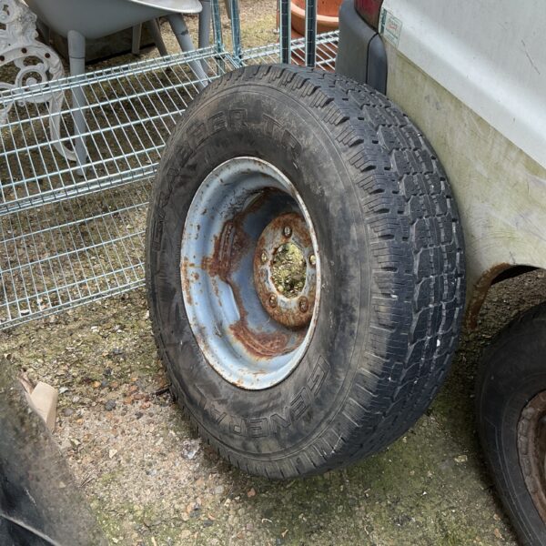 Large van wheel with tyre and signs of wear.
