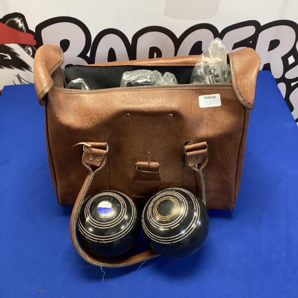 Vintage Henselite lawn bowls set with leather bag for outdoor games.