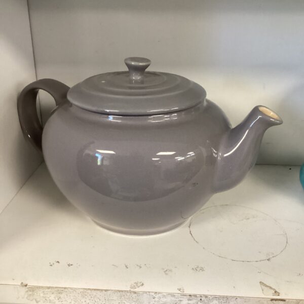 Grey Le Creuset teapot, classic kitchenware collectible.