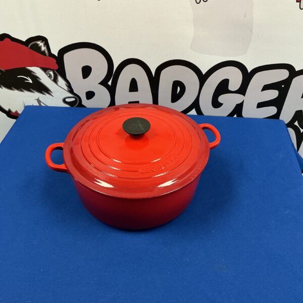 Vintage orange Le Creuset No 28 casserole dish for cooking.