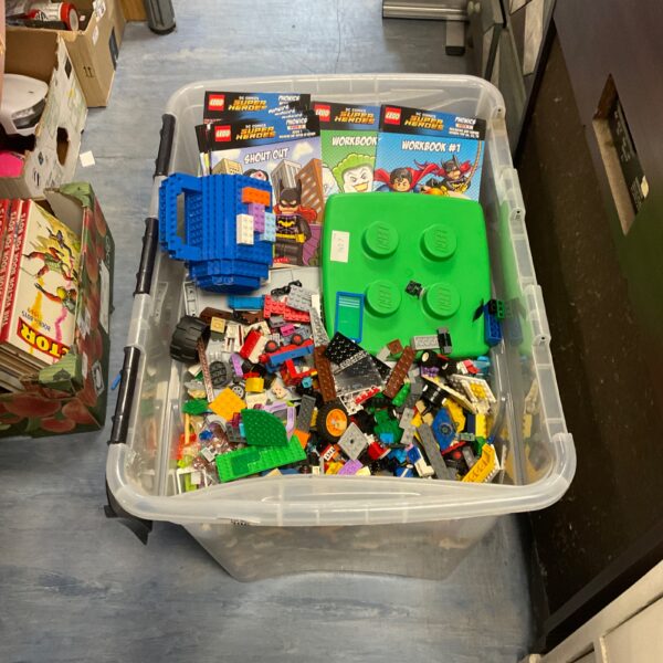 Large lot of Lego bricks with DC Superheroes workbooks included.