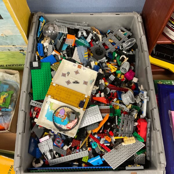 Large assortment of Lego and building blocks with minifigures.